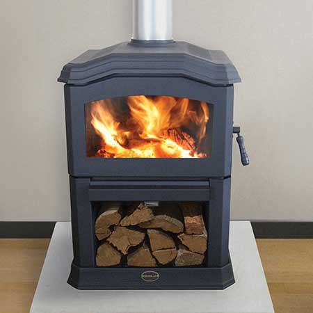 A Kemlan C24 wood burning stove filled with logs, one of the best wood heaters for autumn creating a cosy warm home atmosphere