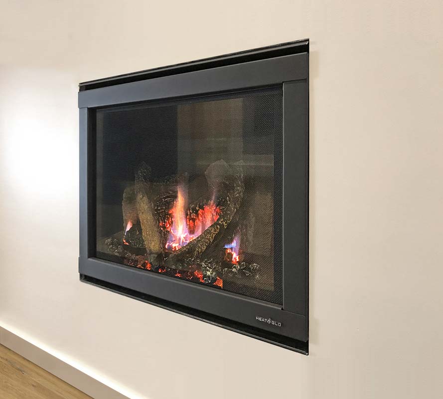 Heat & Glo 5X fireplace built into a wall, a modern gas log fires for homes adding warmth, vibrant flames and a cosy living space