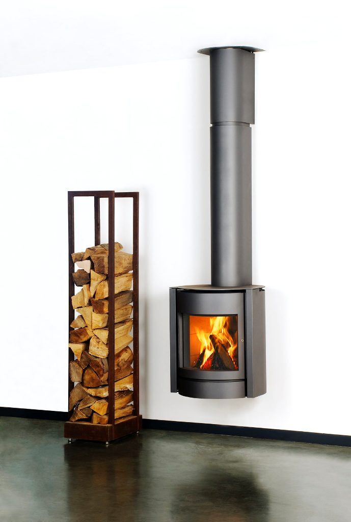 A Stuv 30 UP wood burning stove in a cosy room designed with traditional wood fireplaces Melbourne for warmth and style