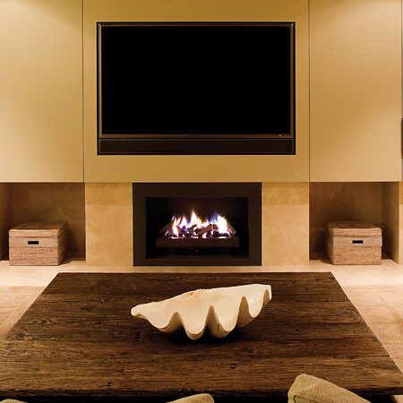 A modern living room with a stylish Real Flame Elegance fireplace and a television above it, perfect modern gas log fires for homes