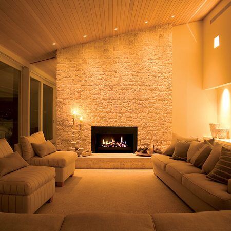 An inviting living room with a stone Real Flame Elegance fireplace, a modern gas log fires for homes