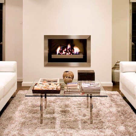 Chic living room with white couches and a Real Flame Elegance fireplace, a stylish option for modern gas log fires for homes