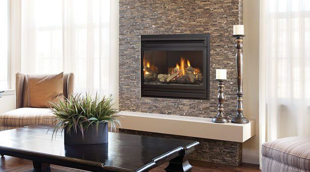A Regency Panorama PG36 fireplace adds autumn warmth to a living room with a table and chairs arranged nearby