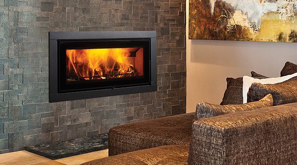 Regency Montrose Large Wood Fireplace installed on a brick wall, one of the best wood heaters for autumn home warmth