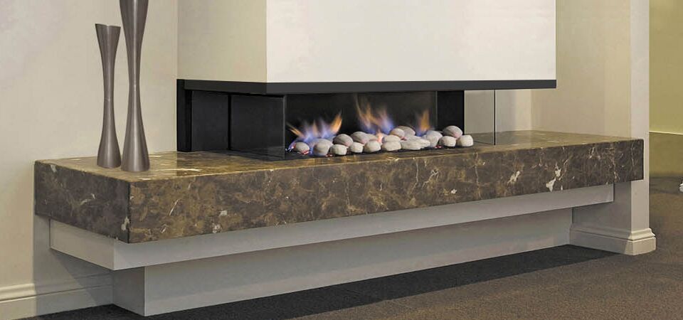 A modern Horizon Cantilever Fire with a sleek marble top, one of the best gas log heaters for autumn adding warmth and style