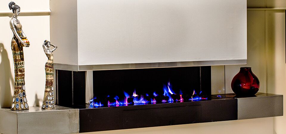 A modern Horizon Cantilever fireplace with a red vase beside it, one of the best gas log heaters for autumn interiors