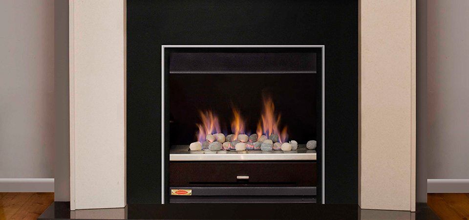 Jetmaster Topaz Series fireplace with a black and white mantle, one of the best fireplaces for autumn warmth and cosy elegance