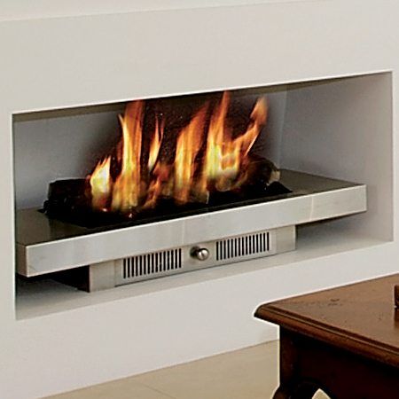 A Real Flame Magiglo fireplace with a glowing fire in a white wall, one of the best gas fireplaces for autumn warmth