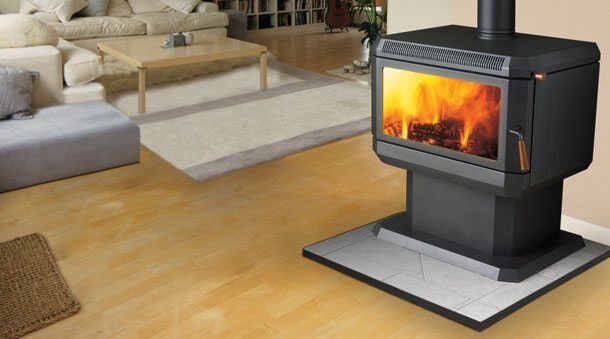 Regency Albany Medium Wood Freestanding stove beside a sofa and table, one of the best wood heaters for autumn warmth