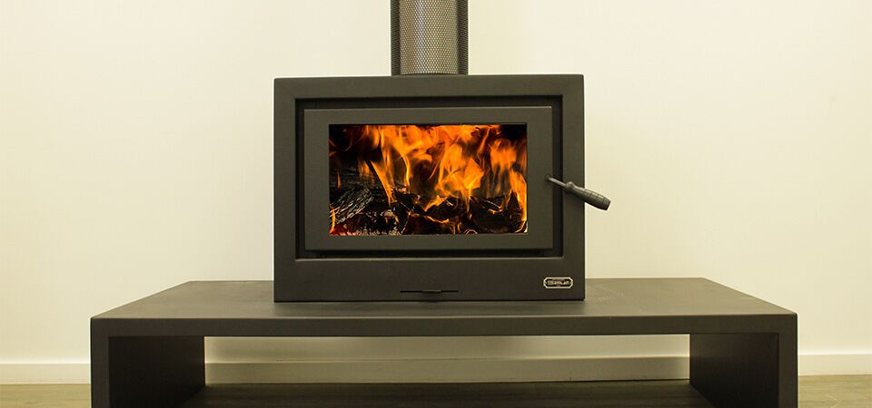 Kemlan Cube wood heater on table, compact and efficient — one of the best wood heaters for autumn