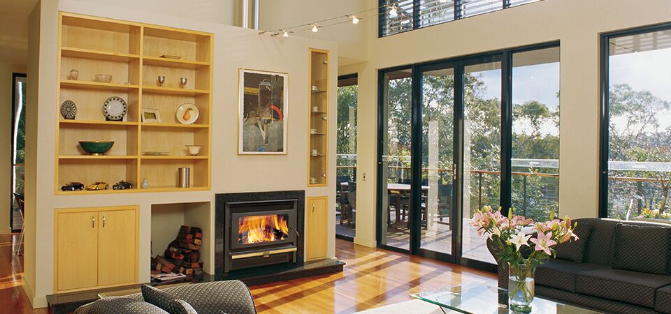 A cosy living room with a Kemlan Super Nova fireplace, one of the best wood heaters for autumn to keep your home warm
