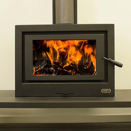 Kemlan Cube wood heater on table, compact and efficient — one of the best wood heaters for autumn