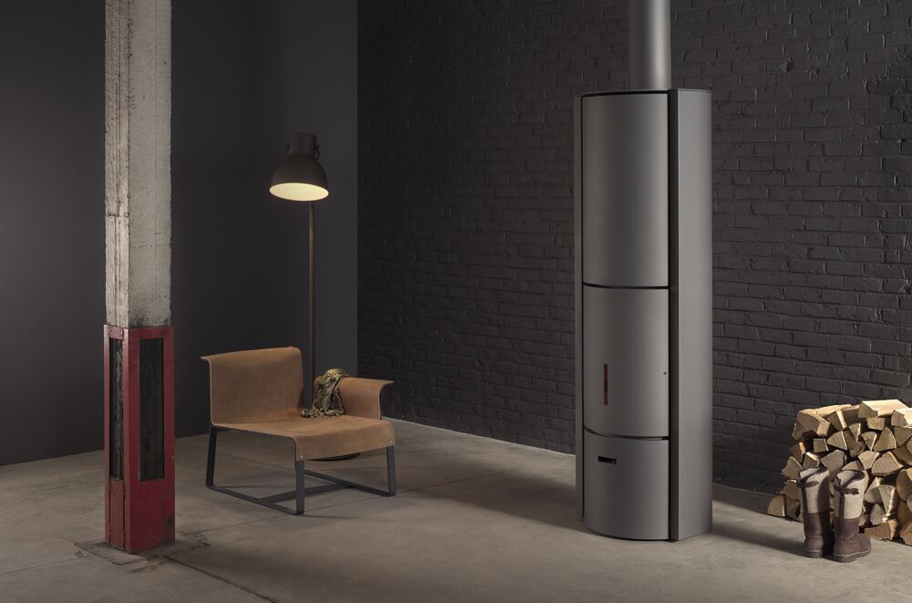 A Stuv 30 HI wood-burning fireplace with chair creating a warm, cosy space, among the best wood heaters for autumn