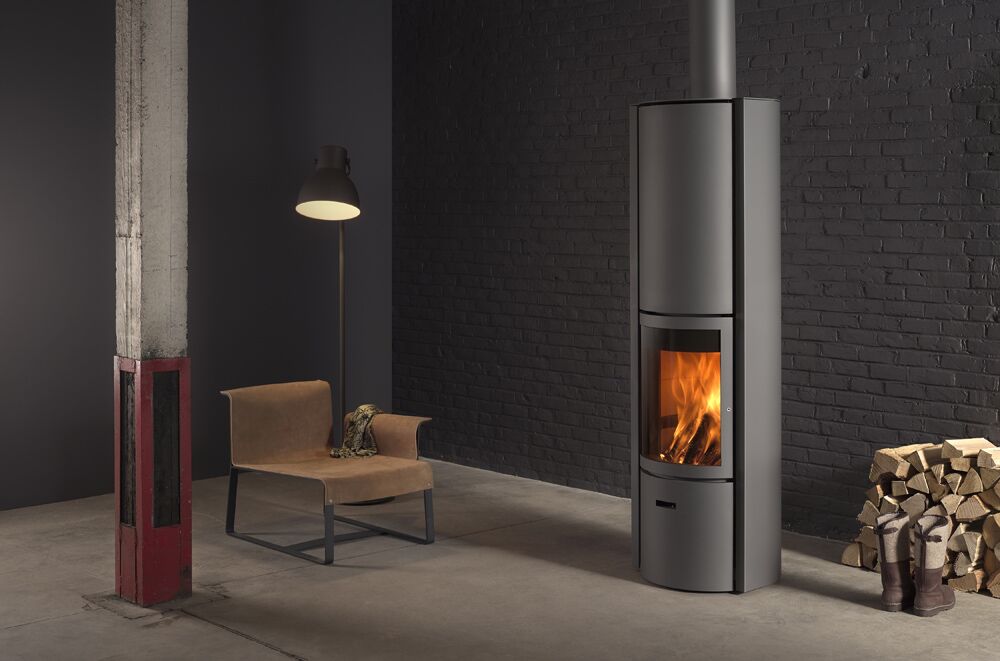 A Stuv 30 HI wood-burning fireplace with chair creating a warm, cosy space, among the best wood heaters for autumn
