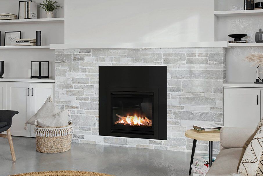 A modern living room featuring a Real Flame Inspire Classic 600 gas fireplace insert and stylish shelves