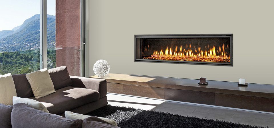 Heat & Glo Mezzo Series fireplace adds warmth and elegance to a living room with mountain views, ideal for modern gas log fires for homes