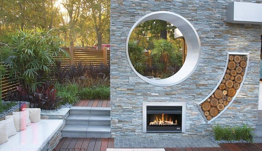 Elegant outdoor open wood fireplace with logs in a lush garden, perfect for enjoying the best wood heaters for autumn