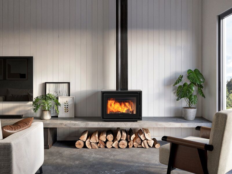 Stylish living room with indoor plant next to Regency Bondi Wood Heater Freestanding, adding warmth and comfort to the interior space