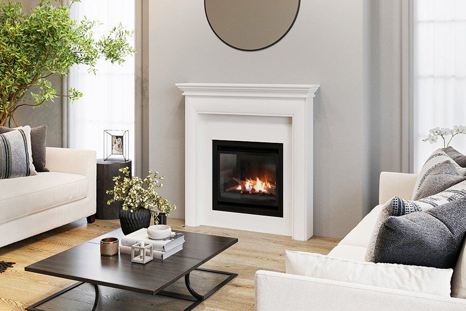 A cosy living room with a Real Flame Inspire Classic 600 gas fireplace insert and a plush couch for relaxation