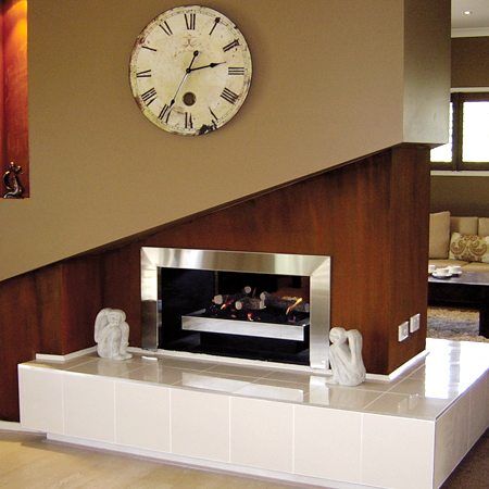 Real Flame Double Vision gas log fire for homes with a wall-mounted clock, adding warmth and style to the living space