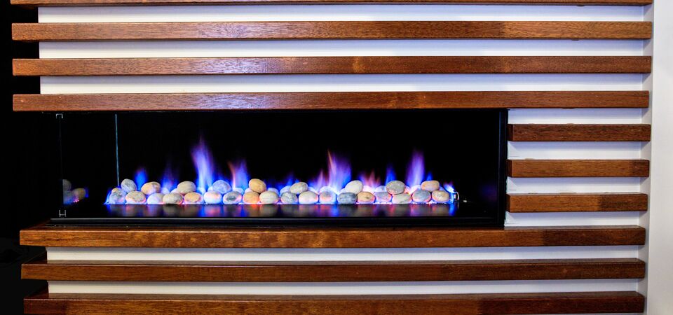 Modern gas log fires for homes with a sleek 3-sided Horizon fireplace and stone surround creating a warm atmosphere