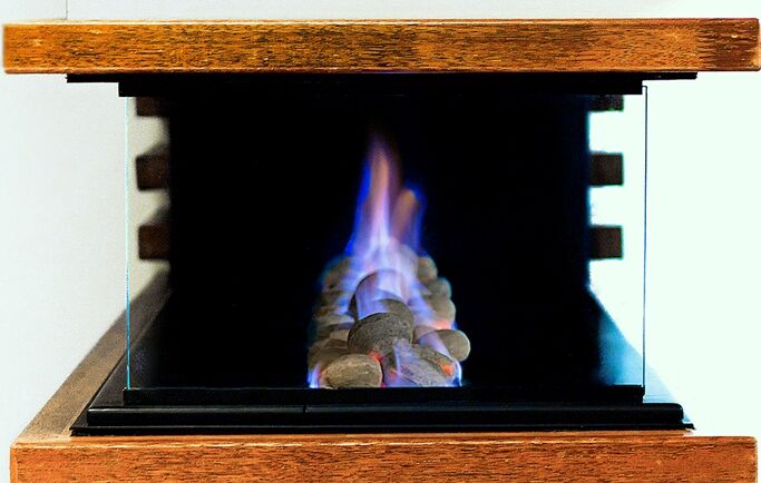 Horizon 3 Sided Fire with glass door showing a vibrant flame inside, a stylish choice among modern gas log fires for homes