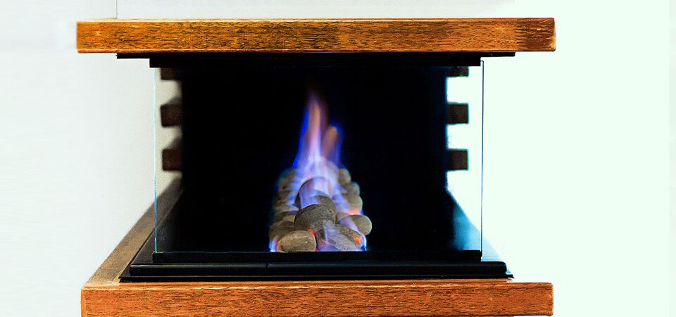 Horizon 3 Sided Fire with glass door showing a vibrant flame inside, a stylish choice among modern gas log fires for homes