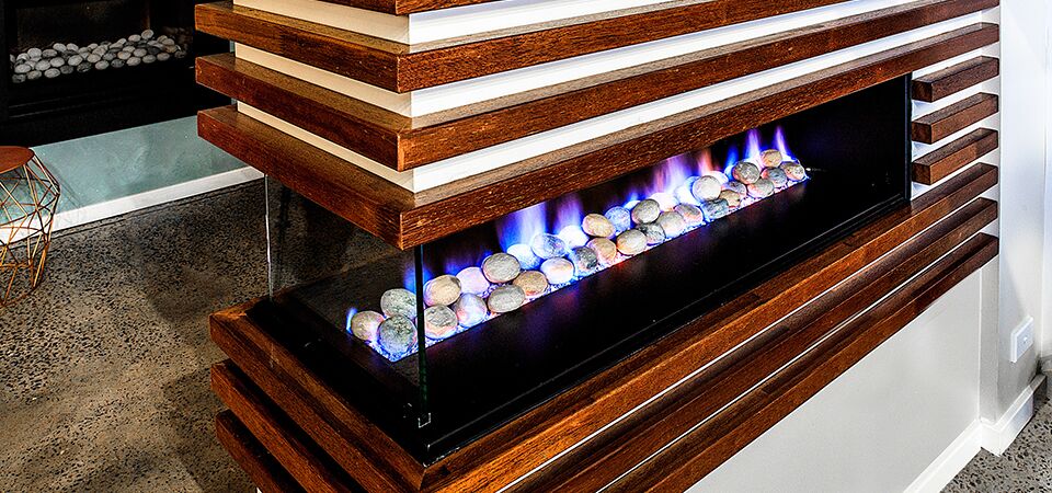 Modern gas log fires for homes with a sleek 3-sided Horizon fireplace and stone surround creating a warm atmosphere