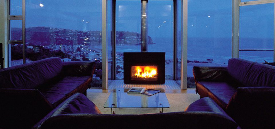 A stylish living room with a Jetmaster Universal Freestanding fireplace, one of the best fireplaces for autumn warmth