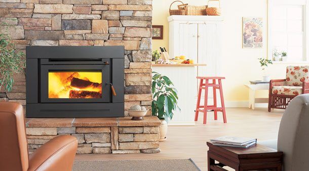 A Regency Bellerive Large Wood Inbuilt stove warms a cosy living room, one of the best wood heaters for autumn comfort