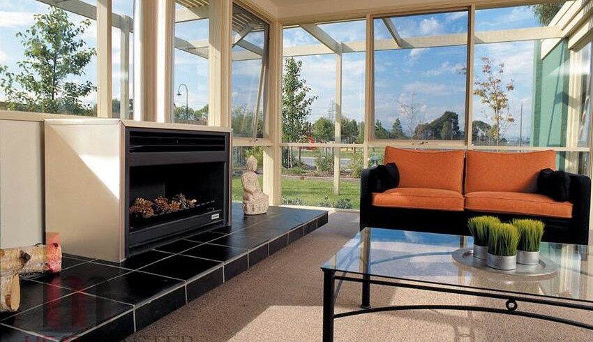Open wood fireplace in a glass living room, perfect for warmth and comfort with the best wood heaters for autumn