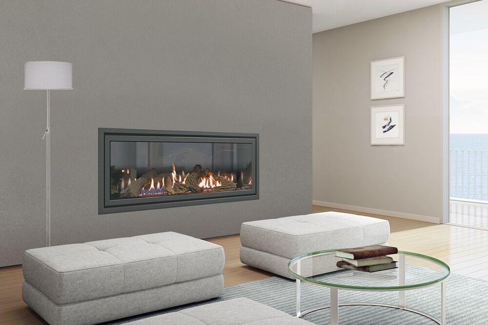 A stylish living room with Heat & Glo SLR-X fireplace and ocean view, showcasing modern gas log fires for homes with elegance