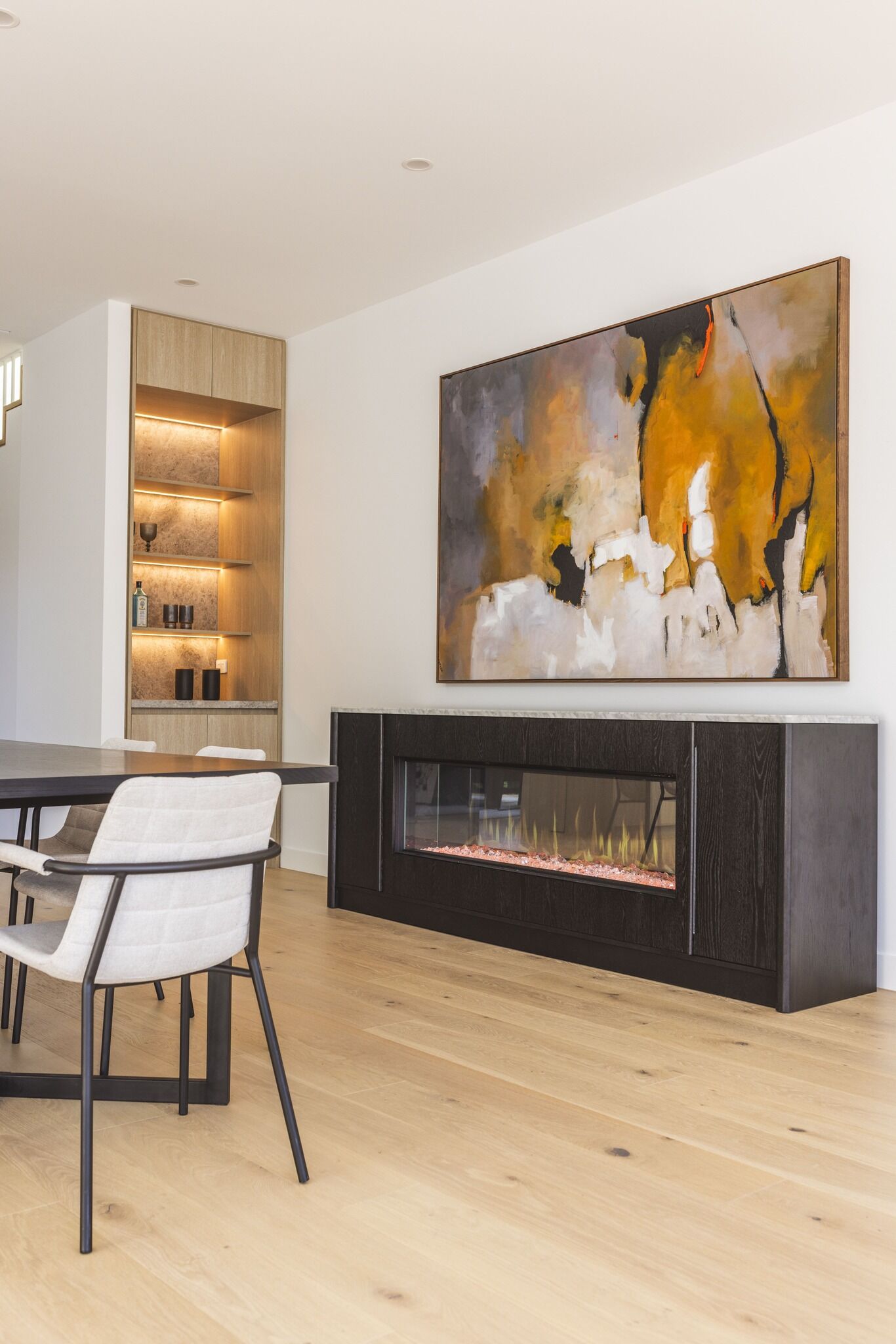 Modern living room with electric fireplace and wall art, with the Ember Arc Grange 240 adding warmth and style to the space