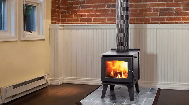 Regency Narrabri Small model wood heater placed against warm brick walls, one of the best wood heaters for autumn comfort