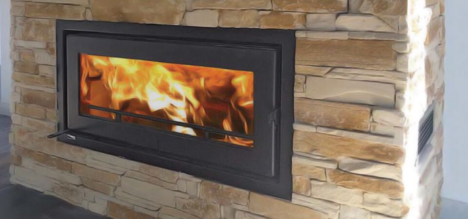 A Kemlan Celestial C900 fireplace with a vibrant fire burning brightly inside installed in a brick wall, one of the traditional wood fireplaces Melbourne