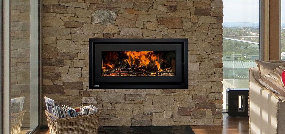 Kemlan Celestial C900 fireplace warms a cosy living room with ocean views, one of the best wood heaters for autumn comfort