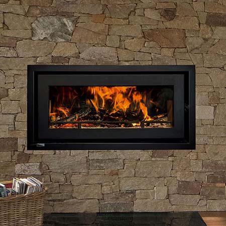 Jetmaster Celestial freestanding wood heater set in a brick wall, one of the best wood heaters for autumn home warmth
