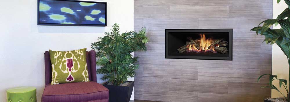 A Regency GF950L gas fire with a cosy sofa and an indoor plant beside it, creating a warm living room atmosphere