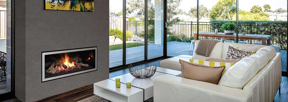 A cosy living room featuring a Regency GF950L gas fireplace and a comfortable couch