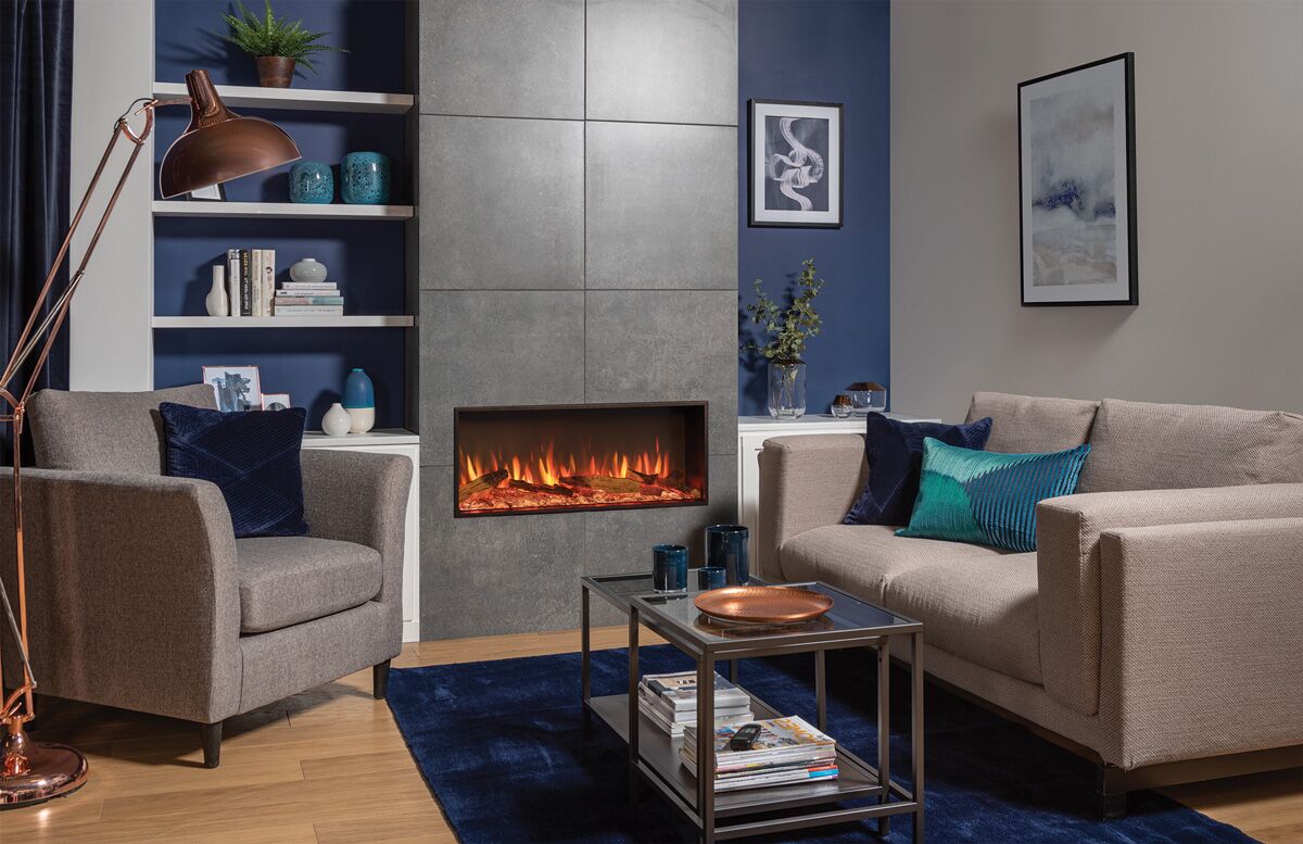 A living room with blue walls and a Regency eStudio ES85R Electric Fireplace as the central element beneath a wall-mounted TV
