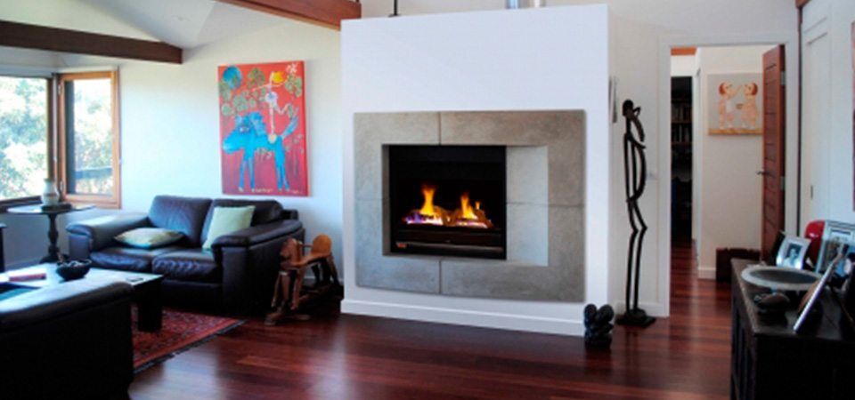 A cosy living room with a Jetmaster Ironbark Logs 850, one of the best gas fireplaces for autumn warmth and comfort