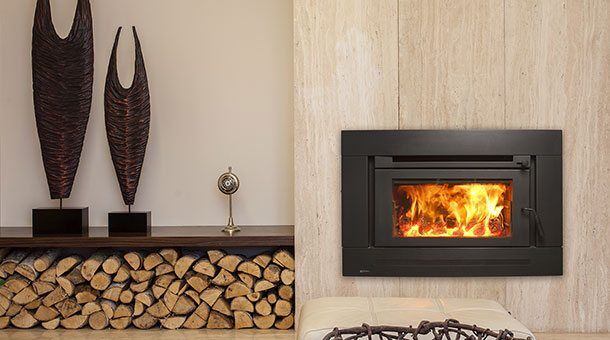 Regency Berwick Medium Wood Inbuilt installed on a wooden wall with a stack of logs beside it and trophies
