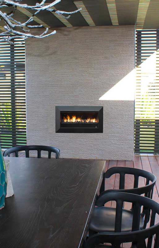 A living room with a Real Flame Exuro fireplace and dining set, displaying modern gas log fires for homes in style