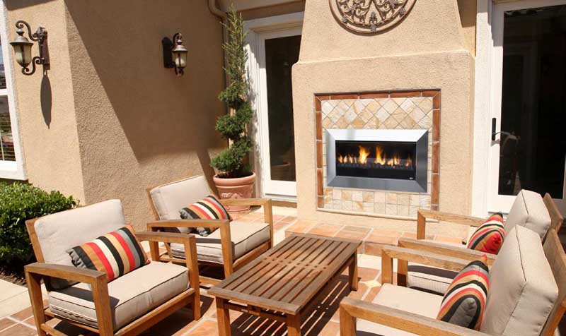 A welcoming patio with a Real Flame Exuro fireplace and comfortable seating, showing modern gas log fires for homes