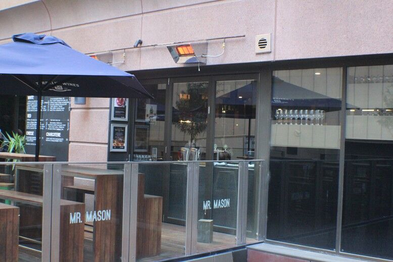 A cosy restaurant with glass doors and a Power Flue System installed, demonstrating modern gas log fires for homes