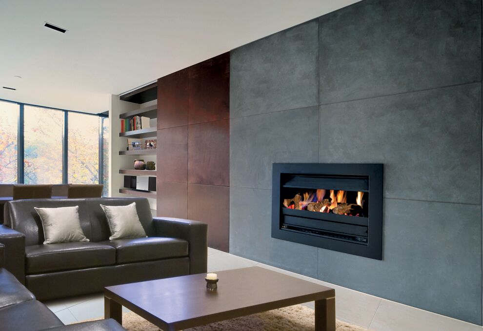 A cosy living room with leather furniture and modern gas log fires for homes, offering efficient heating through a Power Flue System