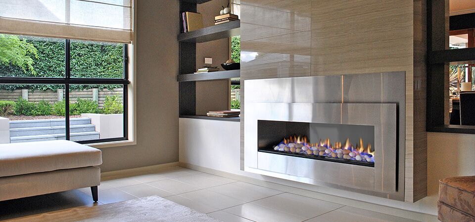 A modern Horizon Low Line inbuilt fireplace beside a large window, one of the best gas log heaters for autumn warmth
