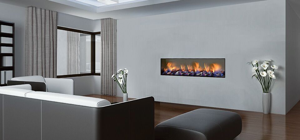 A cosy living room with a Horizon Low Line inbuilt fireplace beside a black and white couch, one of the best gas log heaters for autumn