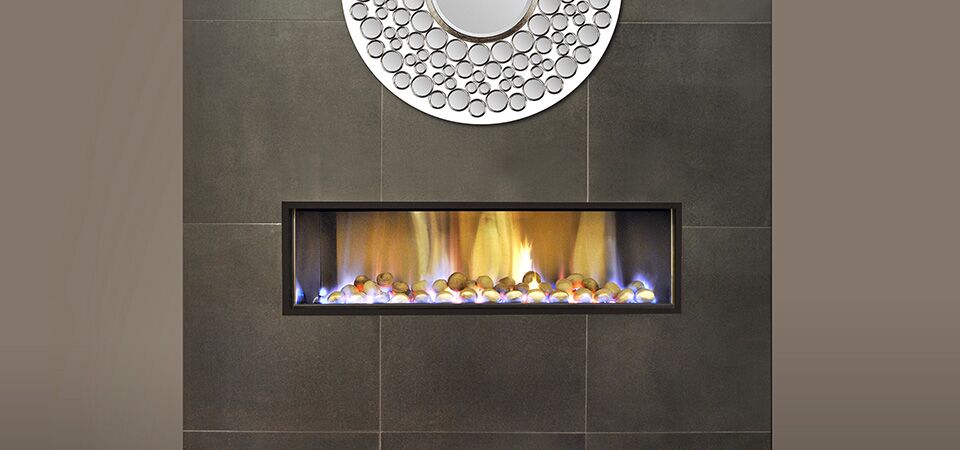 A modern Horizon Low Line Inbuilt Fire with a mirror above it, adding warmth and style as one of the best gas log heaters for autumn