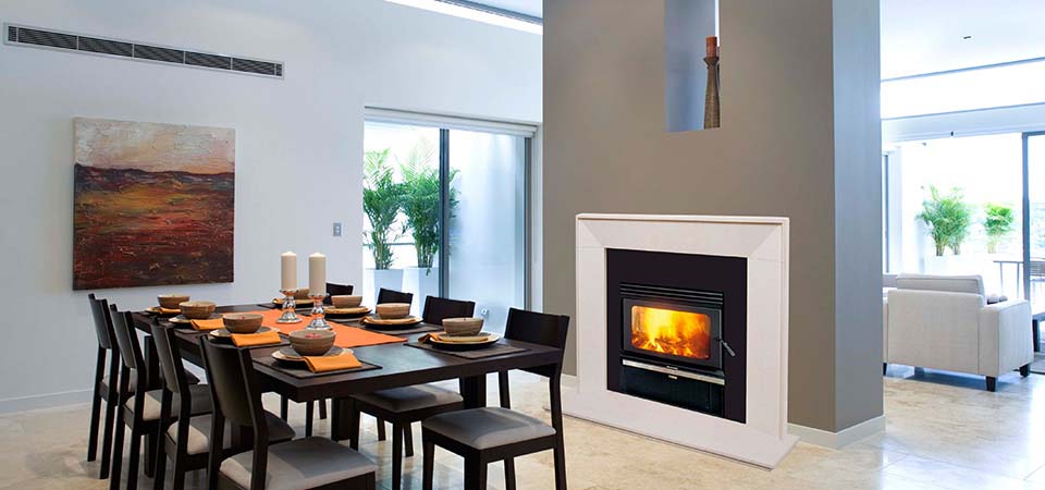 Elegant dining room with a Kemlan Coupe Double Sided Inbuilt fireplace, one of the best wood heaters for autumn